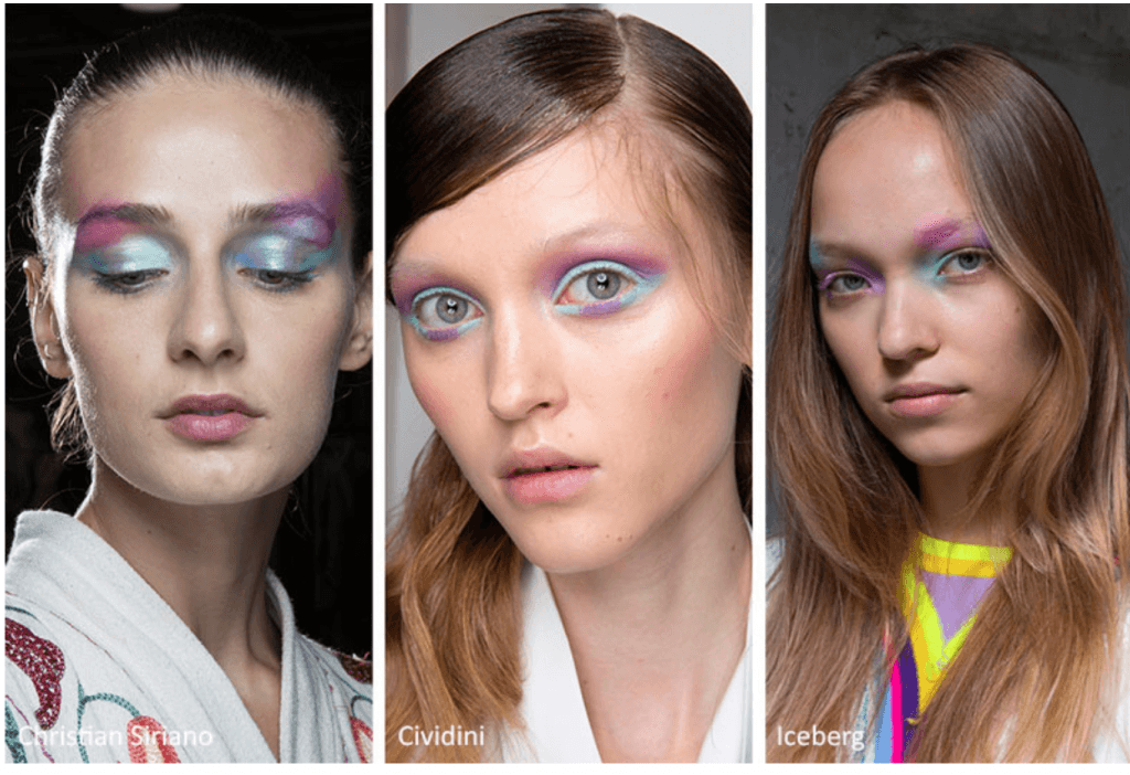 Üç modelin canlı pastel göz makyajıyla moda defile görünümü