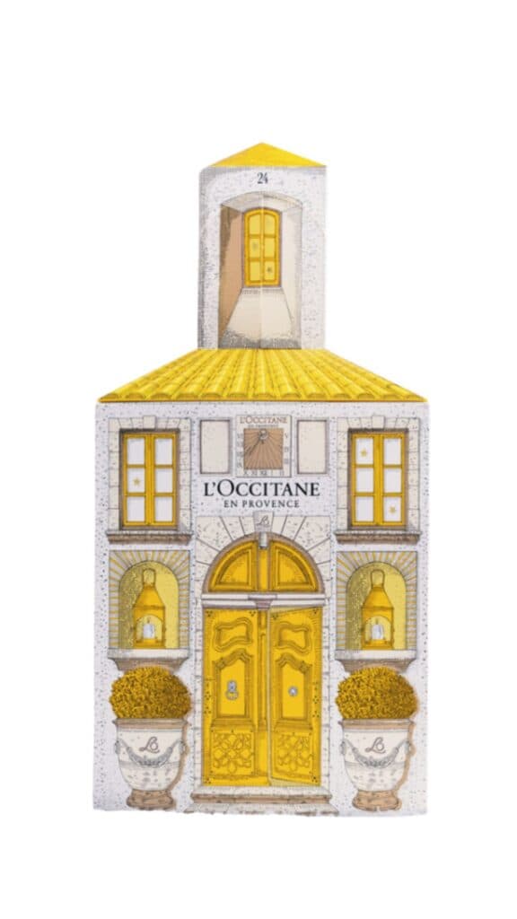 L'Occitane markalı, sarı çatılı ve pencereli ev şeklinde bir kutu