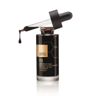Honey Bronze damlalıklı bronzlaştırıcı şişesi, düşen koyu renkli sıvı