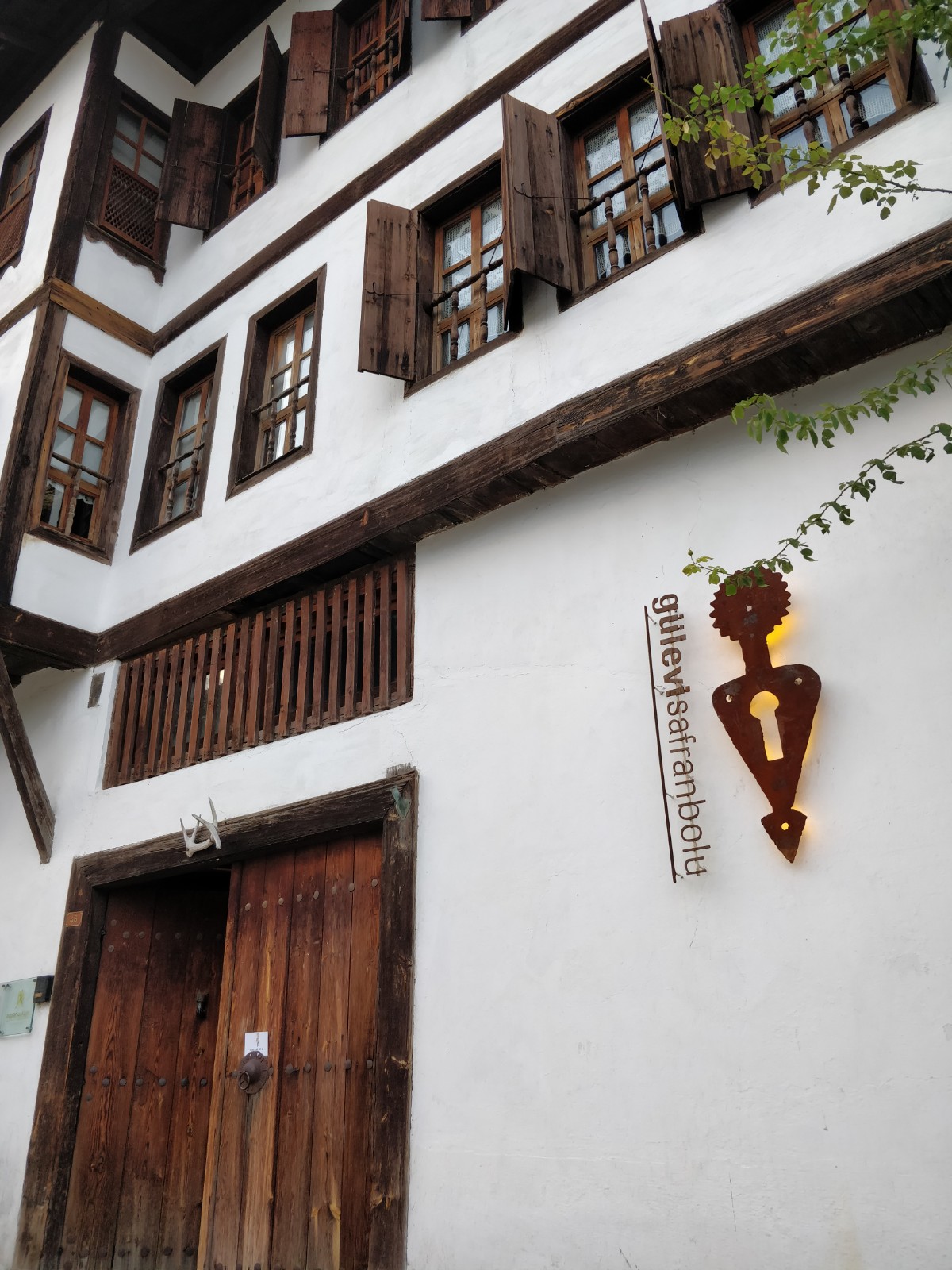 Geleneksel beyaz ev ahşap pencereler panjurlar kapı ve ışıklı tabela