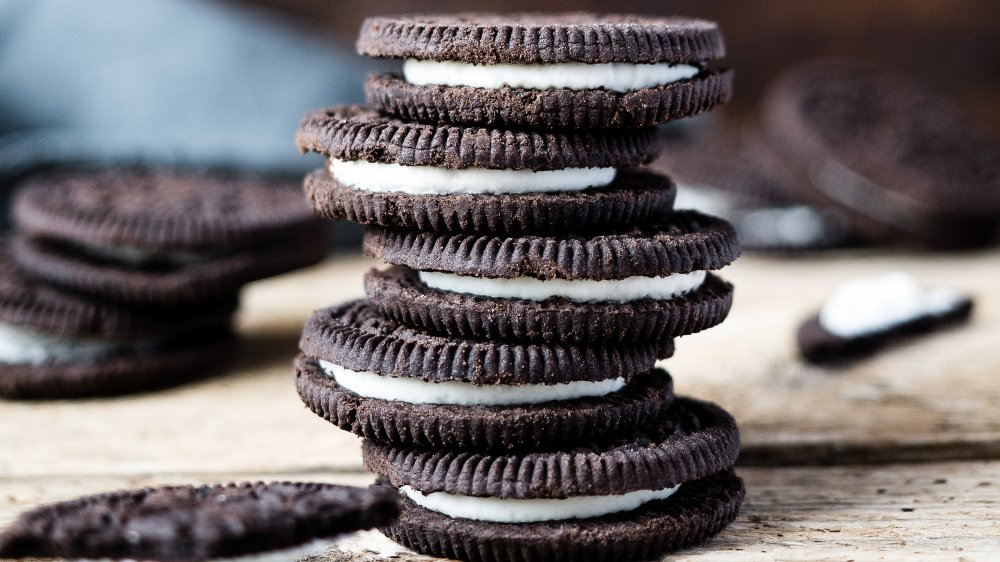 Oreo kurabiyelerinden yapılmış bir kule ve ahşap zeminde dağınık kurabiyeler