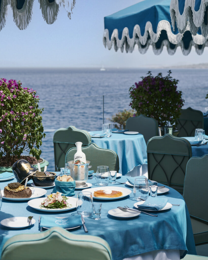 Deniz manzaralı mavi örtülü lüks açık hava restoran masası